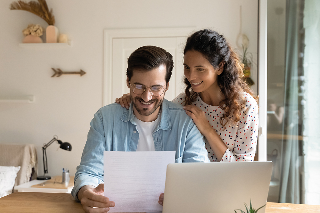 Woman Man reading laptop